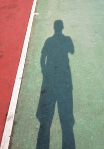 Self Portrait with shadow at tennis court - chee gin - Canva - Getty Images